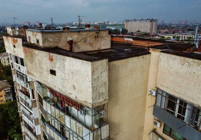 an old building with dirty windows in a city