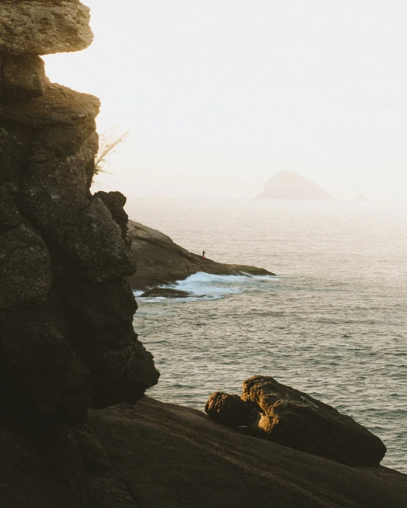 a person climbing onto the side of a cliff