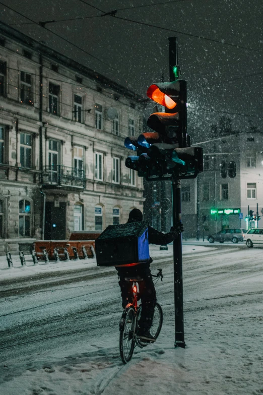 the person is on his bike in the snow