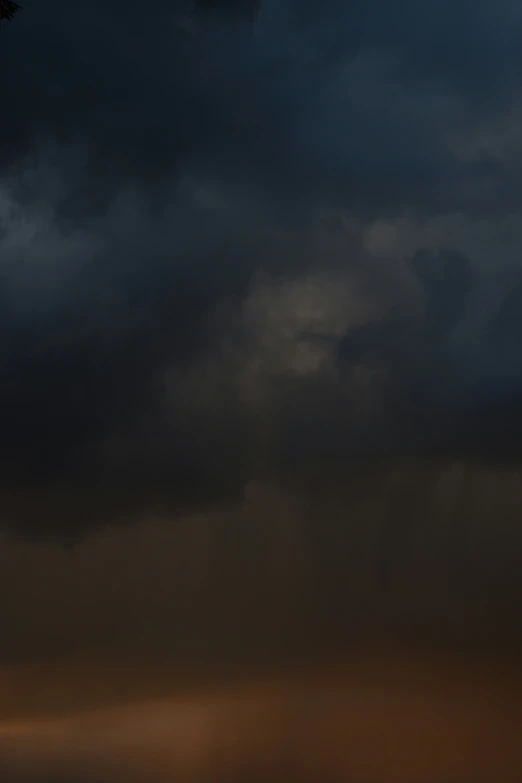 a plane flying against a cloudy sky at night