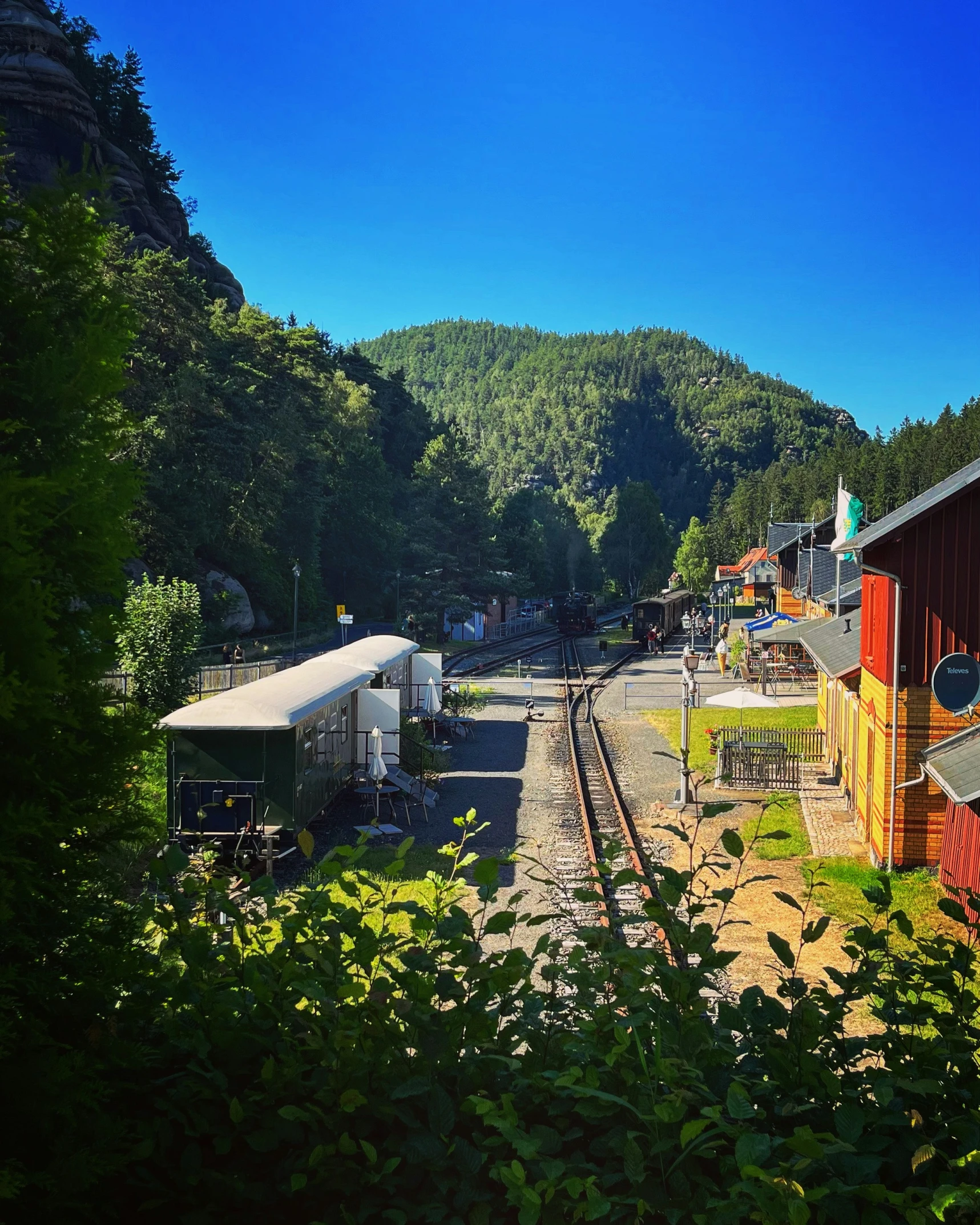 a train is parked next to some buildings