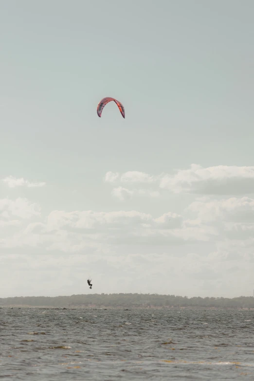 a man is riding on top of an ocean with a parachute