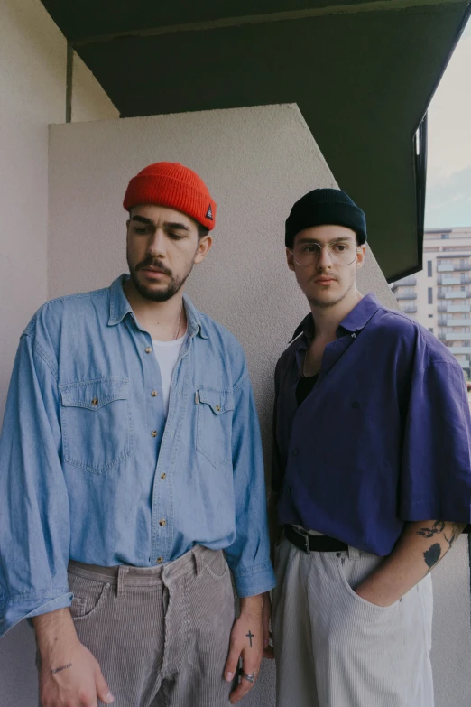 two young men wearing red berets are standing next to each other