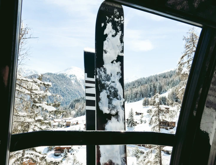 a snowboard is seen through the windows of a cabin