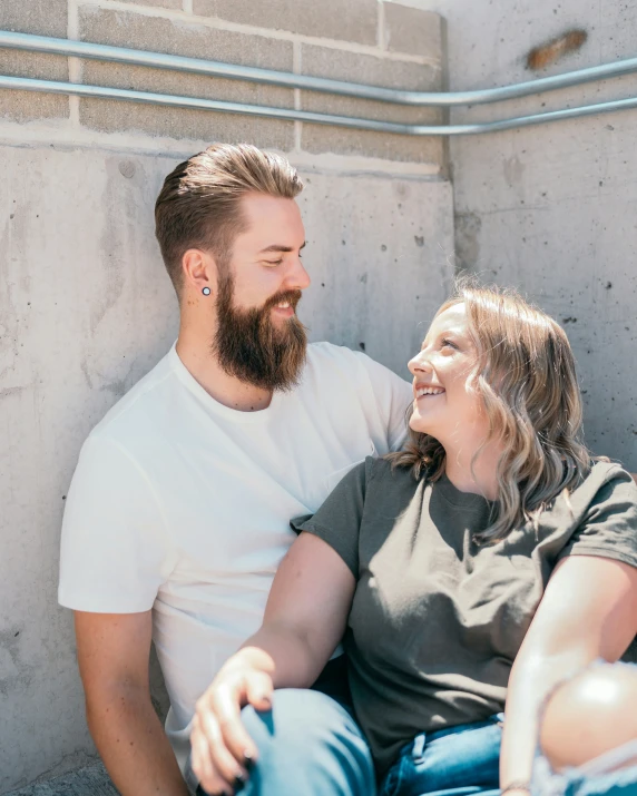 man sitting on bench with woman holding him