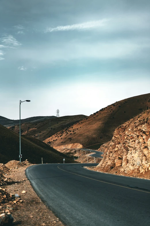 a road in the middle of a rocky valley