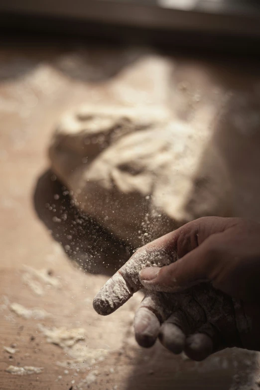 someone is baking in the kitchen with a hand that is sprinkled