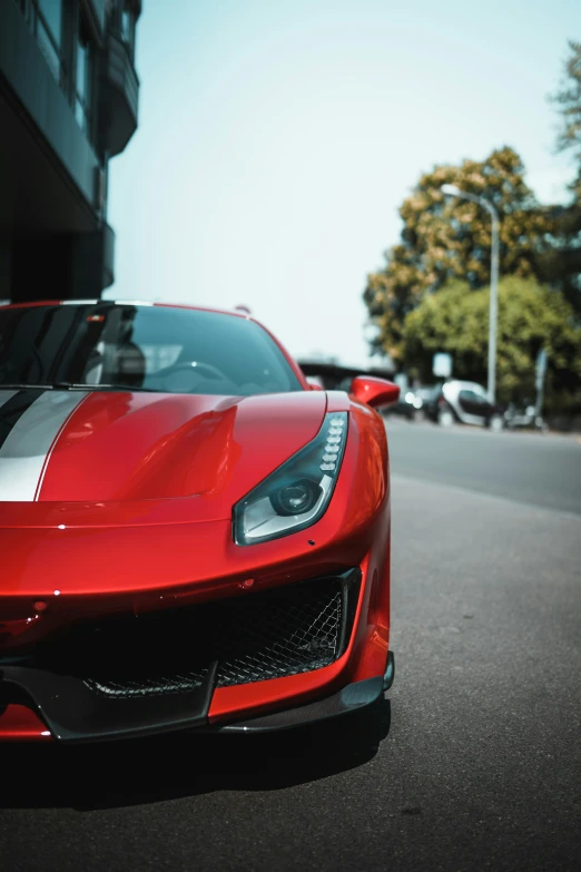 a red sports car parked next to a building