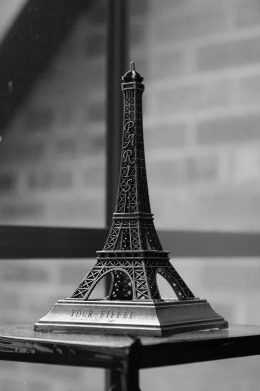 a small model of the eiffel tower in black and white