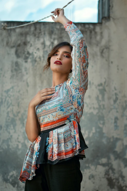 a girl holds onto the string of her shirt