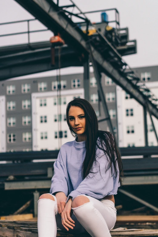 a woman in a white skirt sitting on a deck with her knee high socks