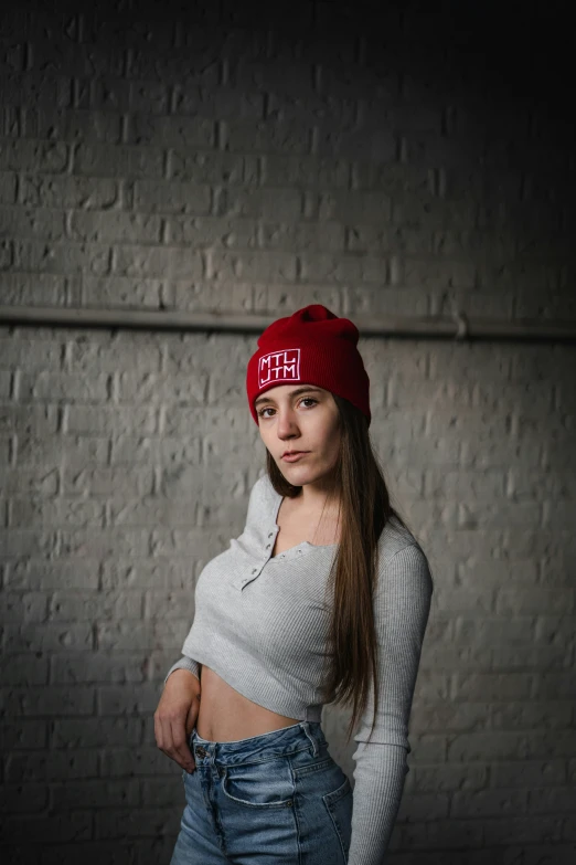 a young woman with long hair wearing a red hat