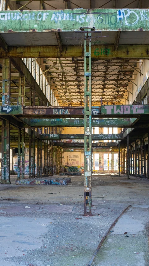 an old industrial building with scaffolding and graffiti