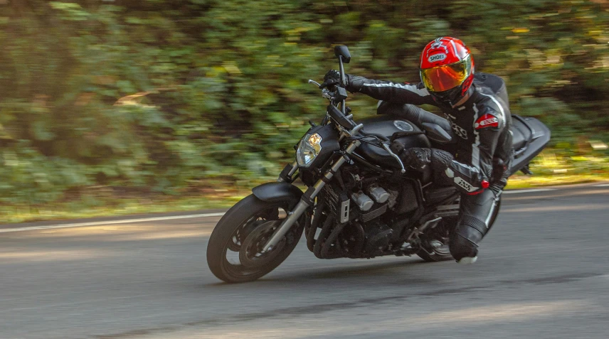 the man on the motorcycle rides the road in a speed