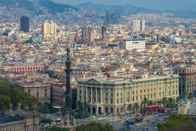 a large building in the city surrounded by mountains