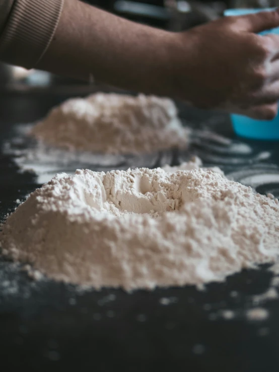 someone is preparing food with flour on the counter