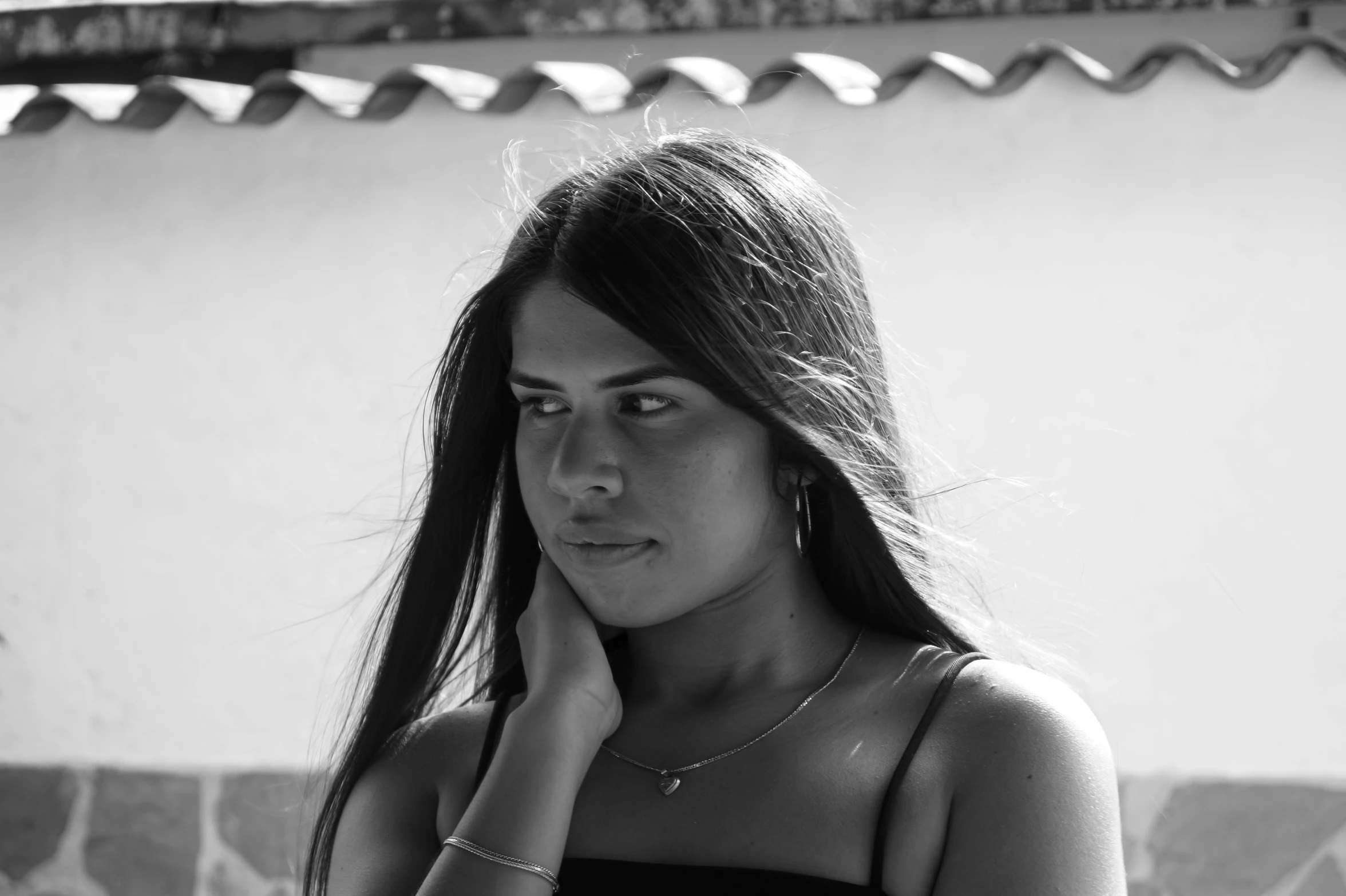 a black and white po of a woman in front of a wall