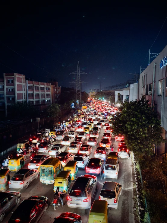 a busy city street filled with traffic in the dark