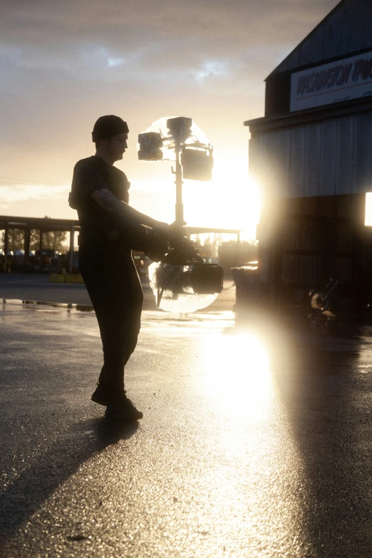 a woman is standing on a wet street