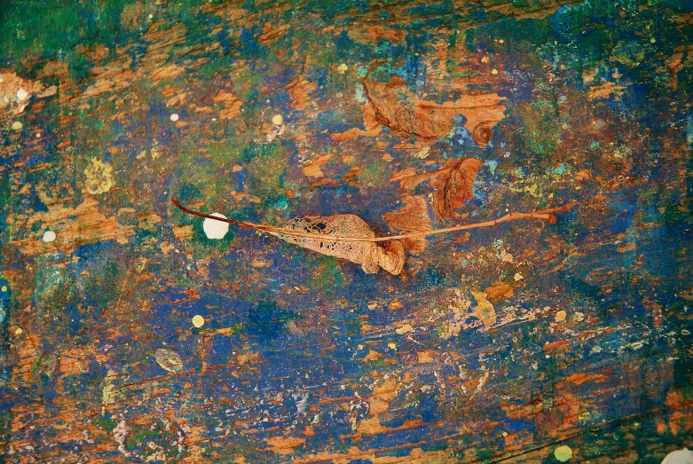 a rusted wall with a cup sitting on it