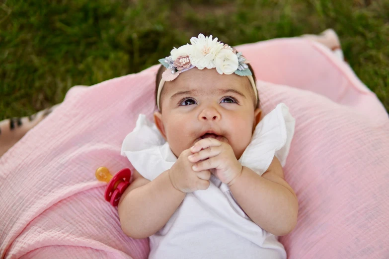 a baby with a flower in her hair