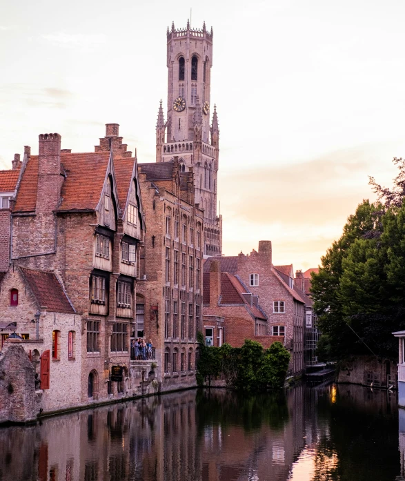 a narrow river with several buildings lining the shore