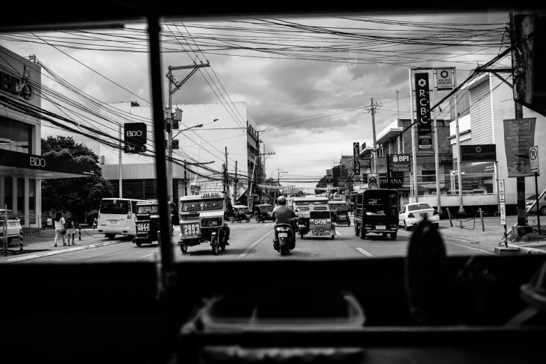 a city street filled with vehicles under power lines