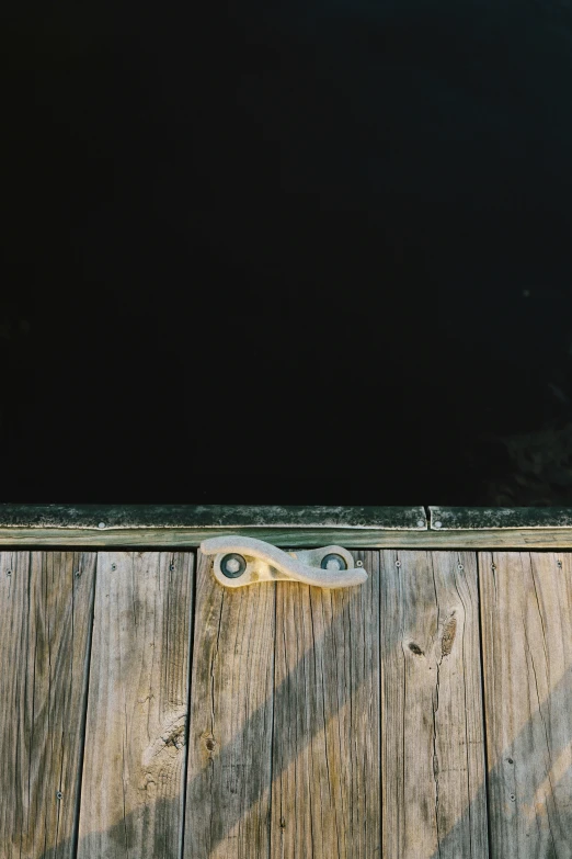 a white shoe is sitting on wooden boards