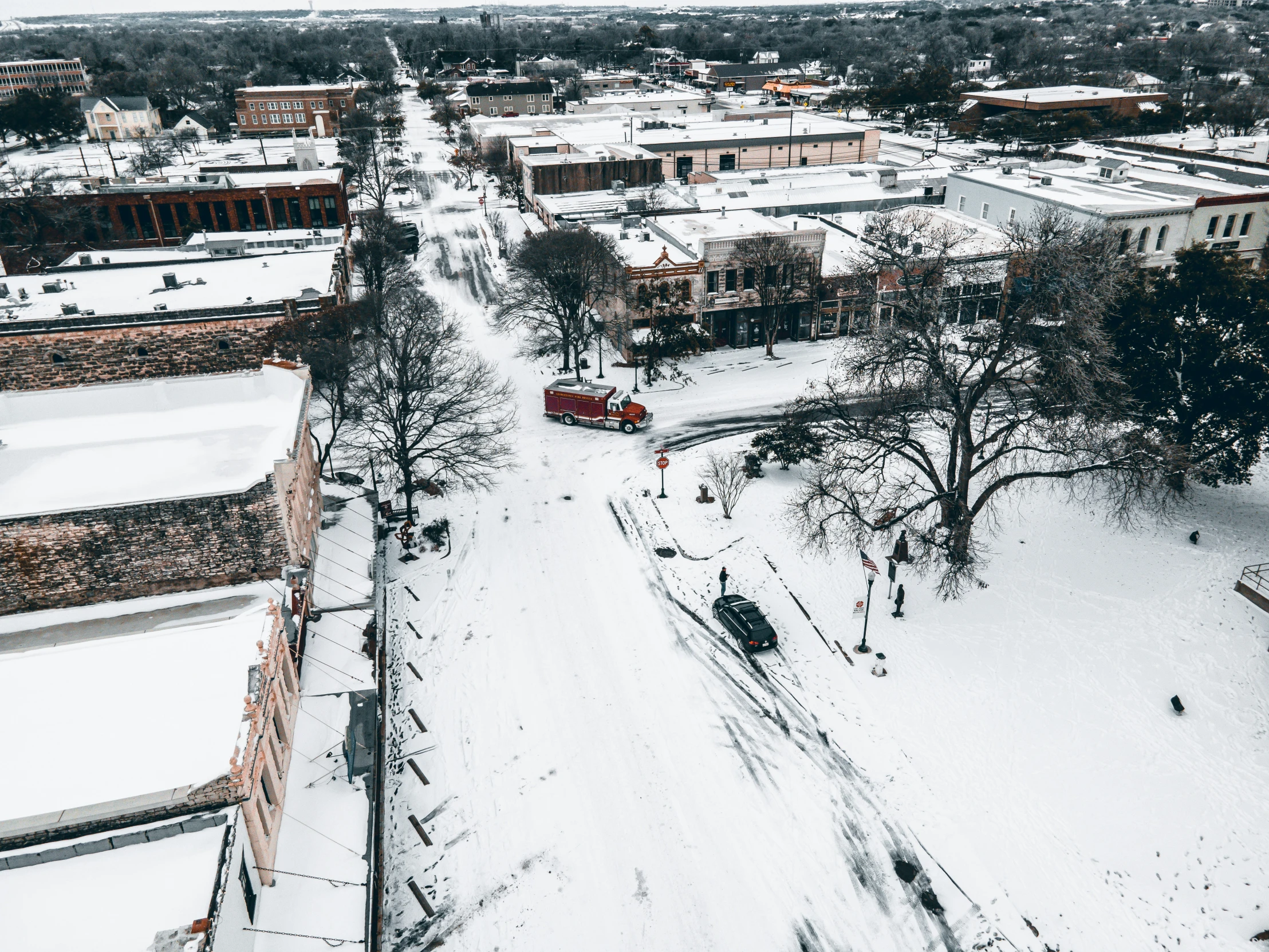 an aerial view of the snow covered streets