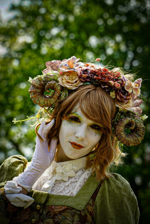 a woman in white is holding a headband with flowers