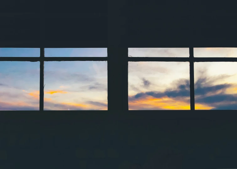 two windows looking into another window at sunset