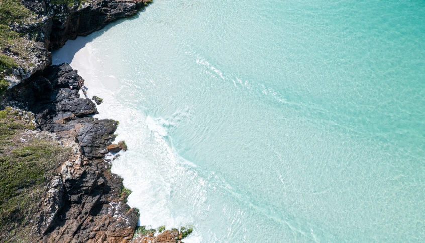 a beach that is in the middle of some water