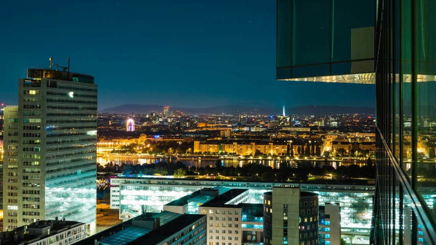 some buildings lights and a very large city at night