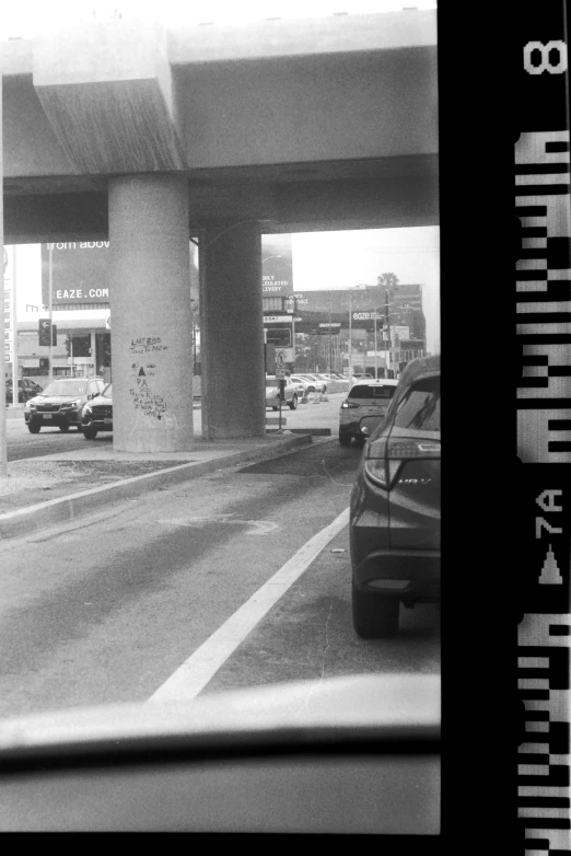 cars passing under a freeway with no lights on