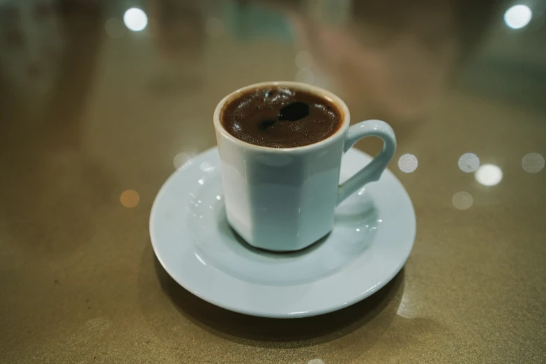 there is a cup of  chocolate in the middle of a saucer