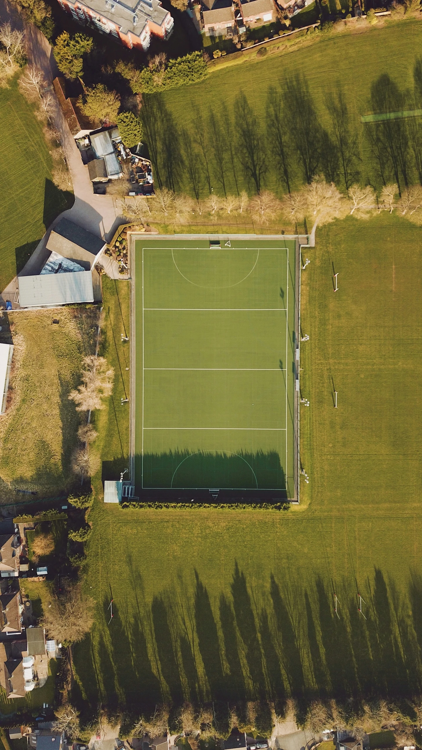 an aerial view of a grassy tennis court