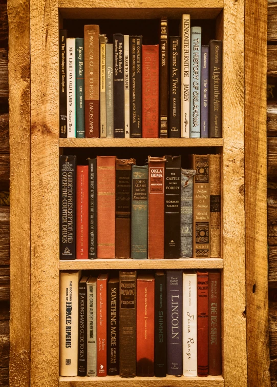 a wooden bookshelf full of different colored books