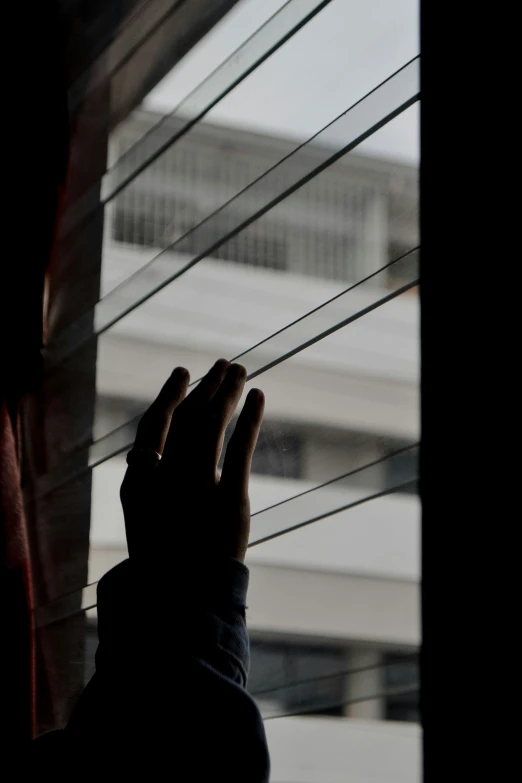 someone is looking out a window at an empty building