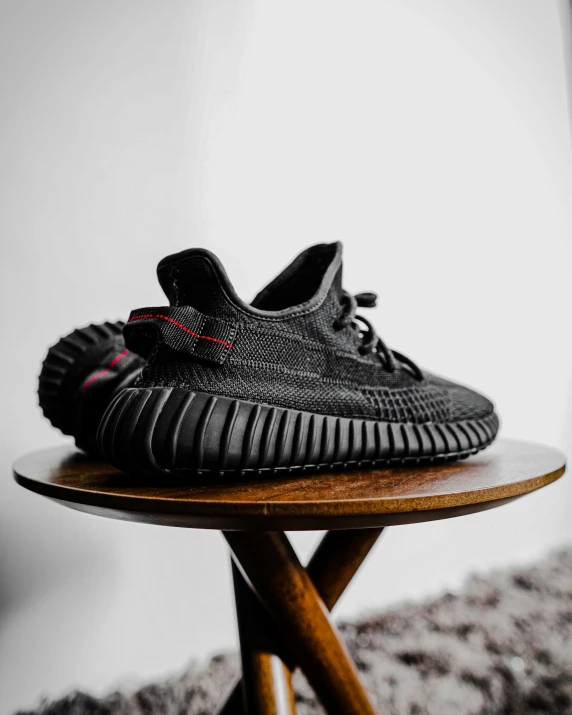 a very nice looking black sneaker on a table