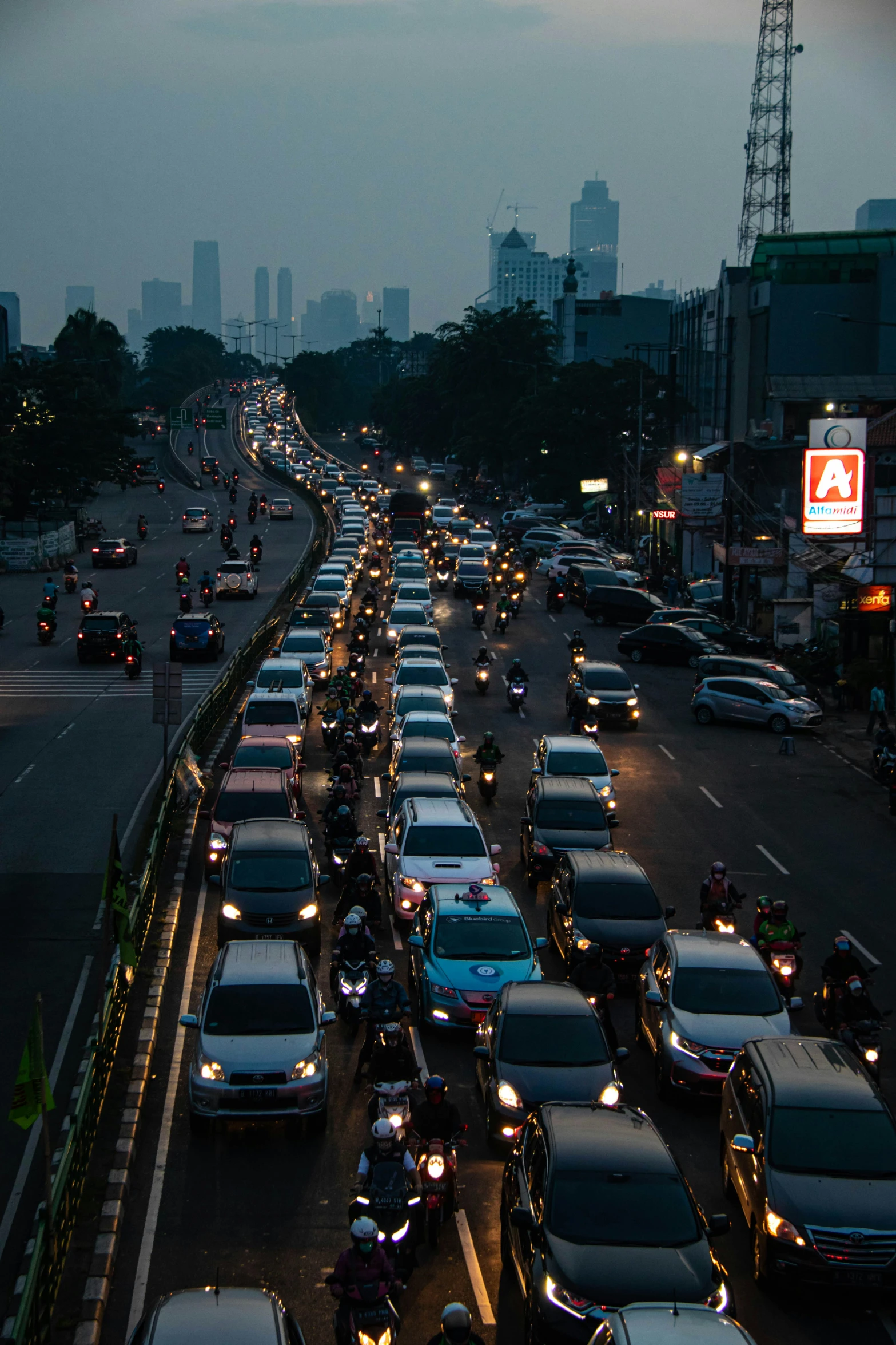 a street filled with lots of cars near tall buildings