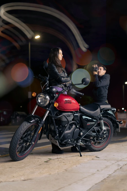 a man and a woman sitting on top of motorcycles