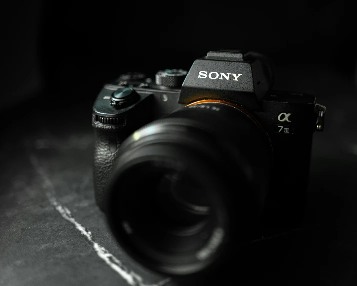 an old sony camera sitting on a black surface