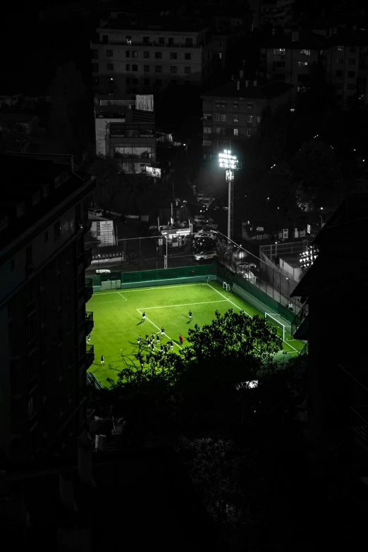 an overview from a distance shows green soccer fields at night