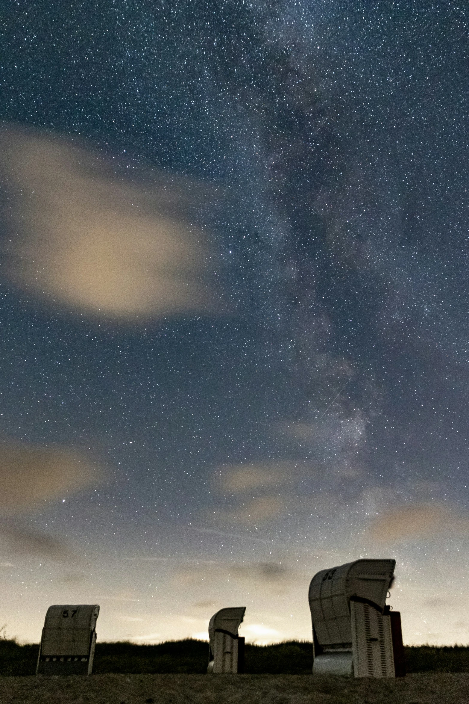 several objects near a body of water on a starry night