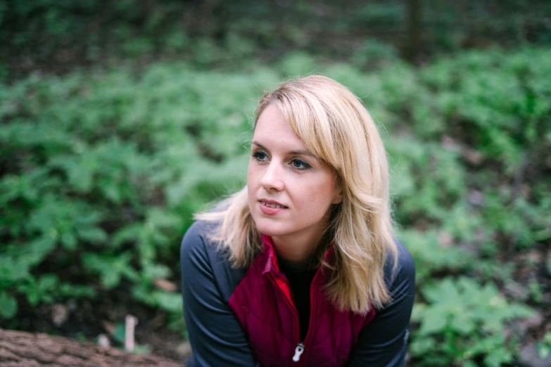 woman looking at the camera in a wooded area