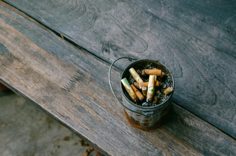 an open can filled with some assorted sticks