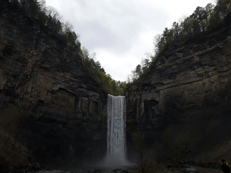 a waterfall in the middle of a canyon