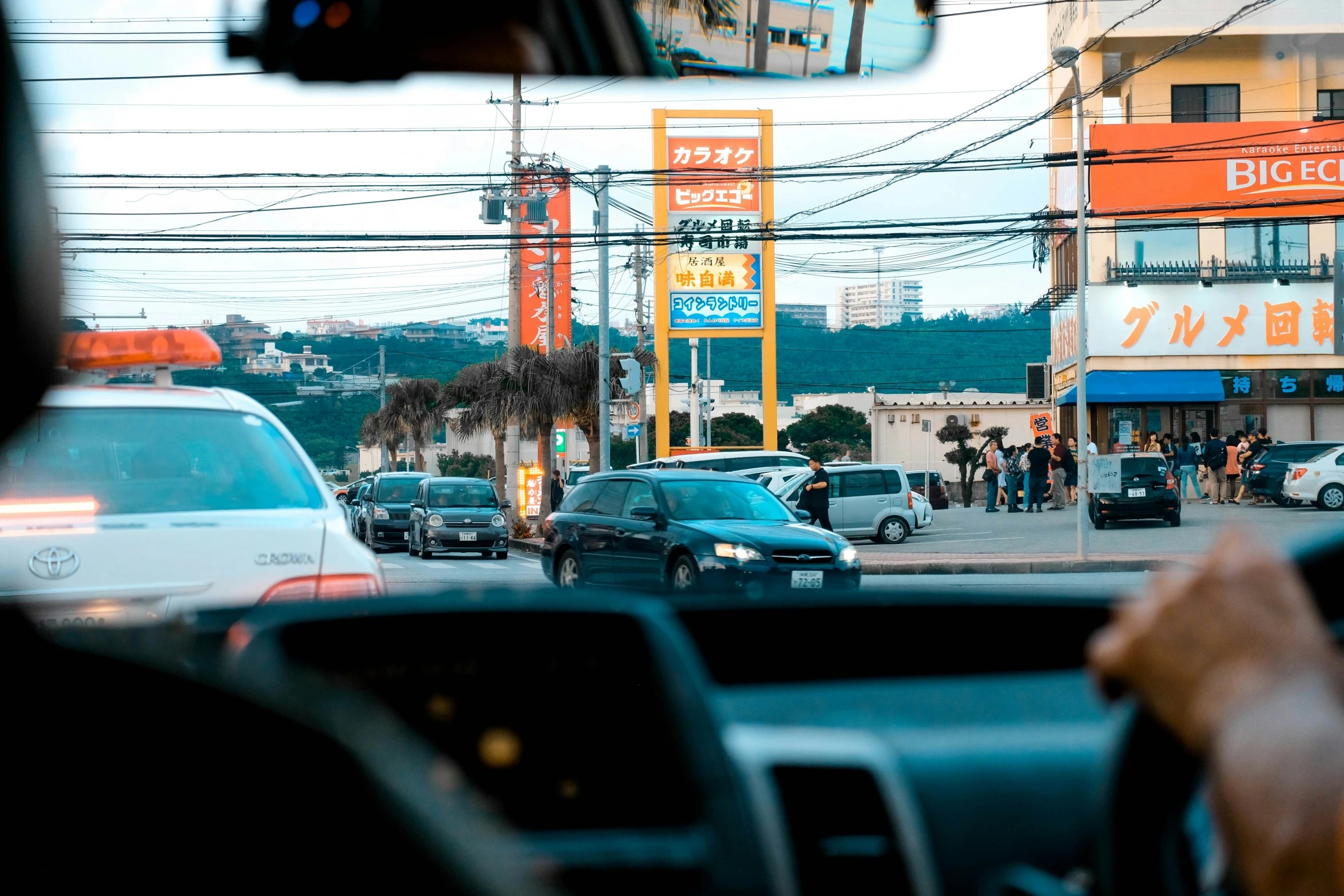 cars and trucks driving down a street during sunset