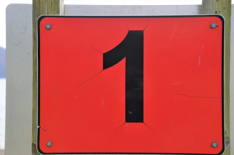 a number sign on an old metal frame