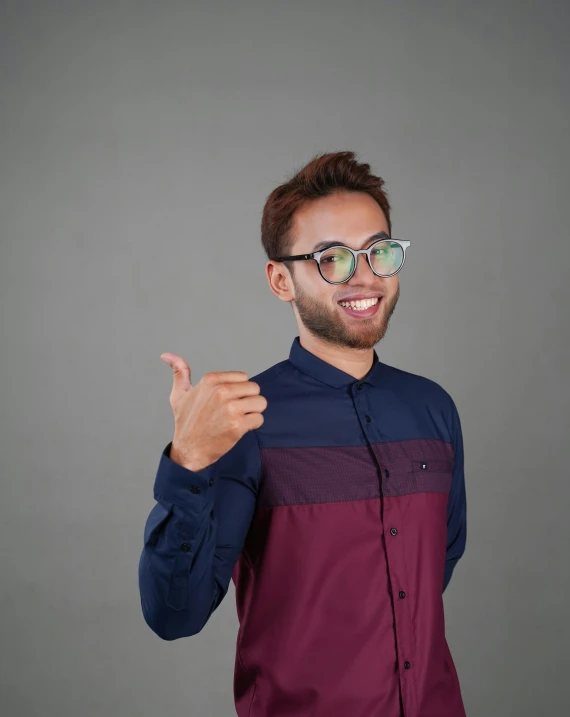 a man in glasses pointing at soing